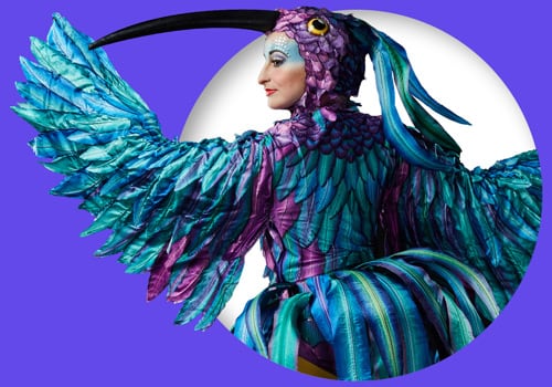 Performer dressed in a hummingbird costume from Luzia.