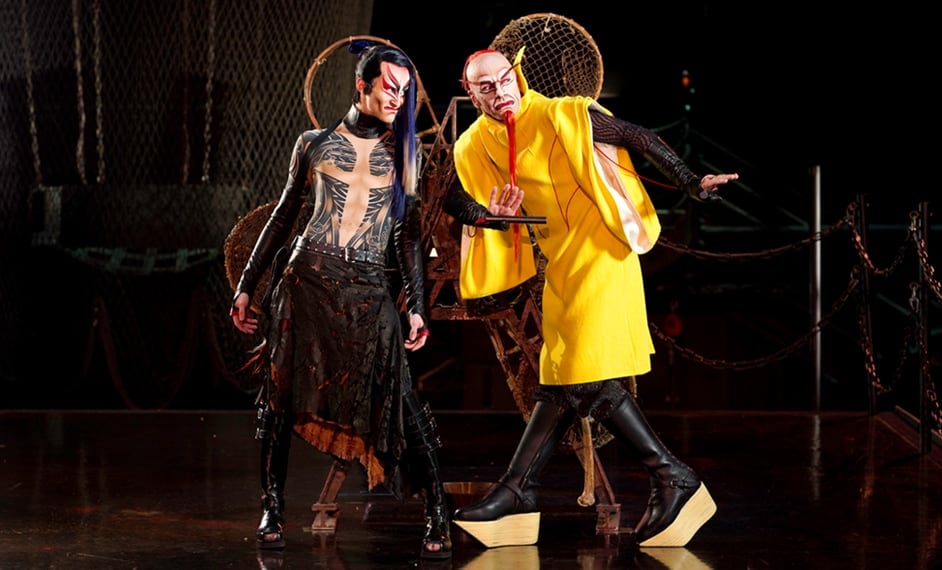 Two men dressed in traditional Asian clothing look like they are going to plot something - Kà by Cirque du Soleil