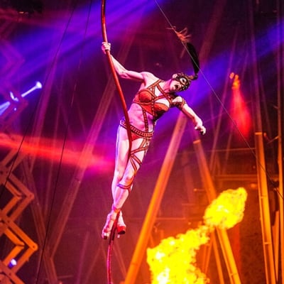 An acrobat performs an aerial number in a colorful and fiery setting – Michael Jackson Las Vegas